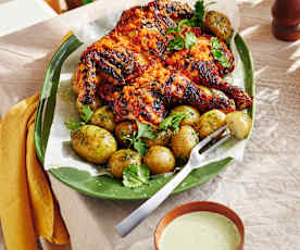 Butterflied spicy chicken with potatoes and coriander dip