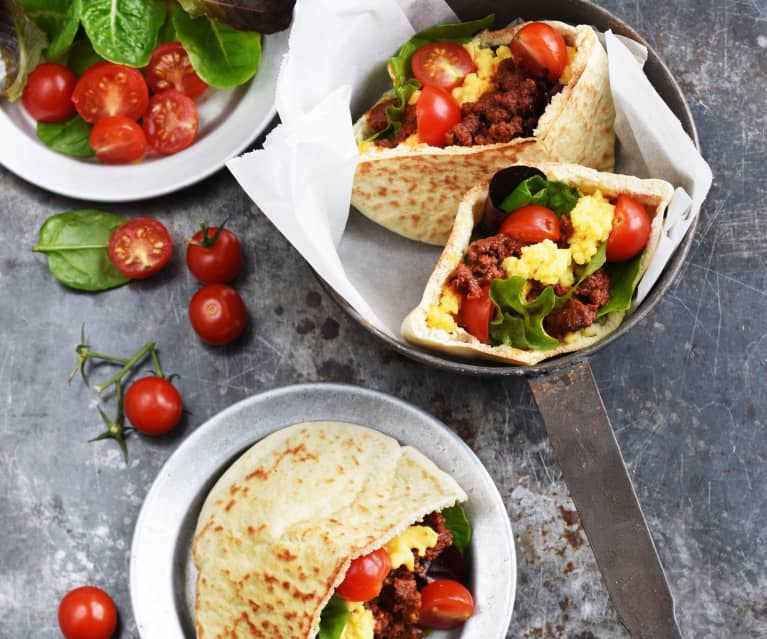 Œufs brouillés aux merguez, tomates et pita grillés