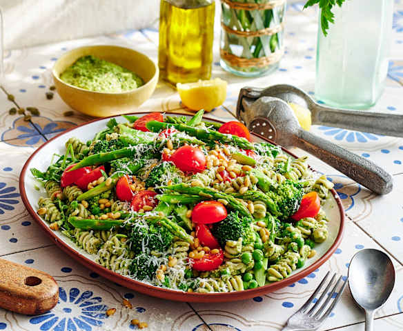 Layered veggie-loaded pesto pasta