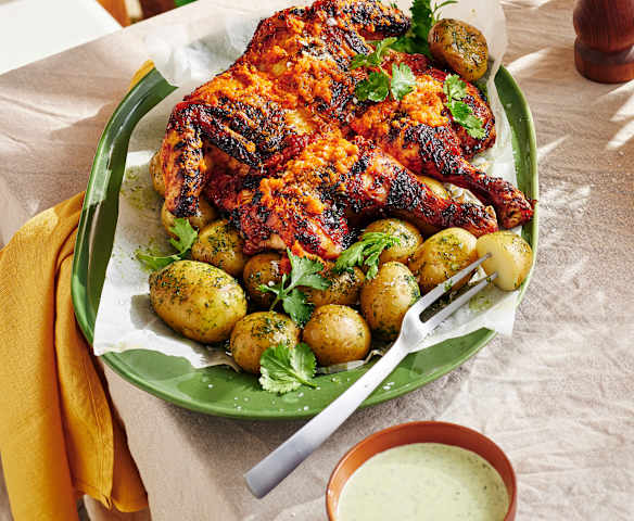 Butterflied spicy chicken with potatoes and coriander dip