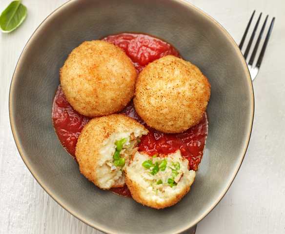 Safranreisbällchen auf Tomatensauce