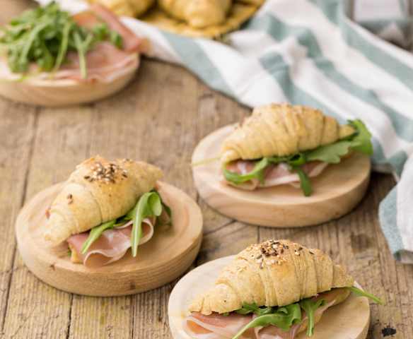 Croissant sfogliati ai cereali con prosciutto crudo e rucola
