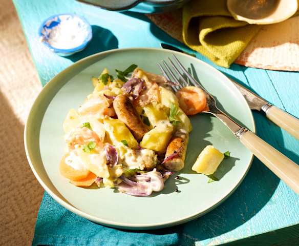 Kartoffel-Möhren-Auflauf mit Würstchen und Kräuter-Käse-Sauce