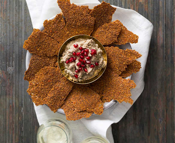 Linseed crackers with mutabbal beitinjan (eggplant dip)