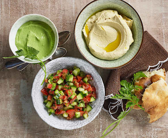 Hummus, grüne Tahina und israelischer Salat Hummus, grüne Tahina und israelischer Salat