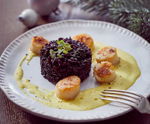 Jakobsmuscheln mit schwarzem Reis und Safran-Sahnesauce