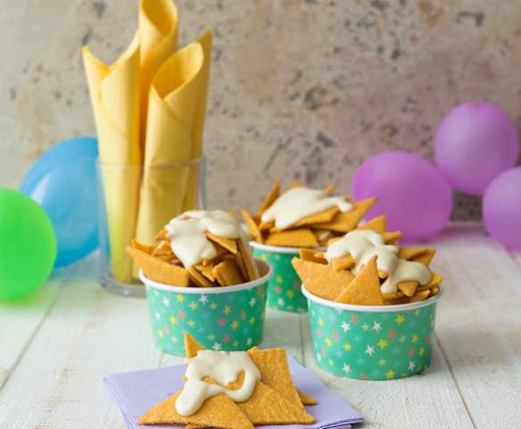 Homemade nacho chips with cheese sauce