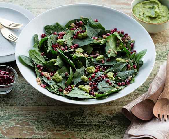 Spinach salad with crunchy quinoa and green goddess dressing