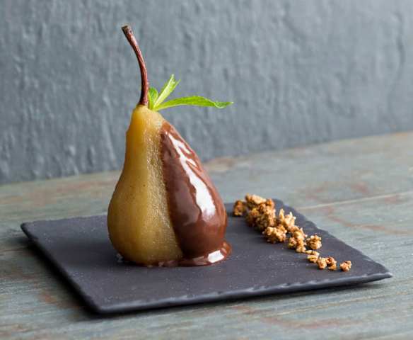Honey poached pears with chocolate sauce and nut crumble
