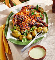 Butterflied spicy chicken with potatoes and coriander dip