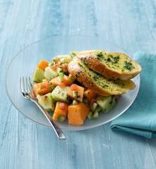 Melon salad with herb and garlic bread