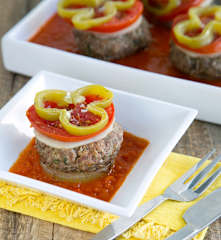 Layered patties and vegetables with bell pepper sauce