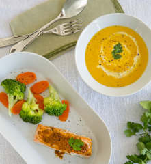 Carrot coriander soup and tikka salmon with steamed vegetables
