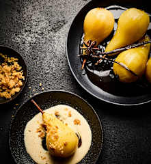 Poached pears on bay leaf crème anglaise and almond crumble
